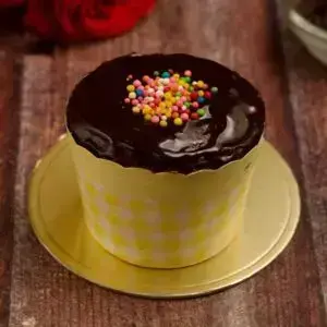 Wholewheat Banana Chocolate chip cupcake made with jaggery, tooped with chocolate sauce